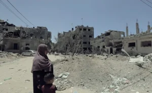 Khalidiya surveys the rubble on a Gaza street